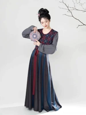 Front full-body view of a dark Blue Tang Dynasty Hanfu set with red navy argyle beizi overlay, grey long-sleeve inner top, striped flowing skirt, and red waist sash