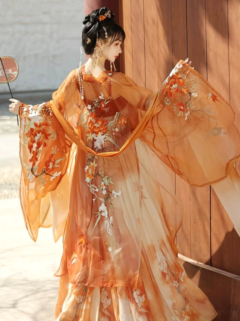 Close-up side view of Tang Dynasty Hanfu bodice and wide sleeve with delicate bird and floral embroidery on lightweight sheer orange fabric