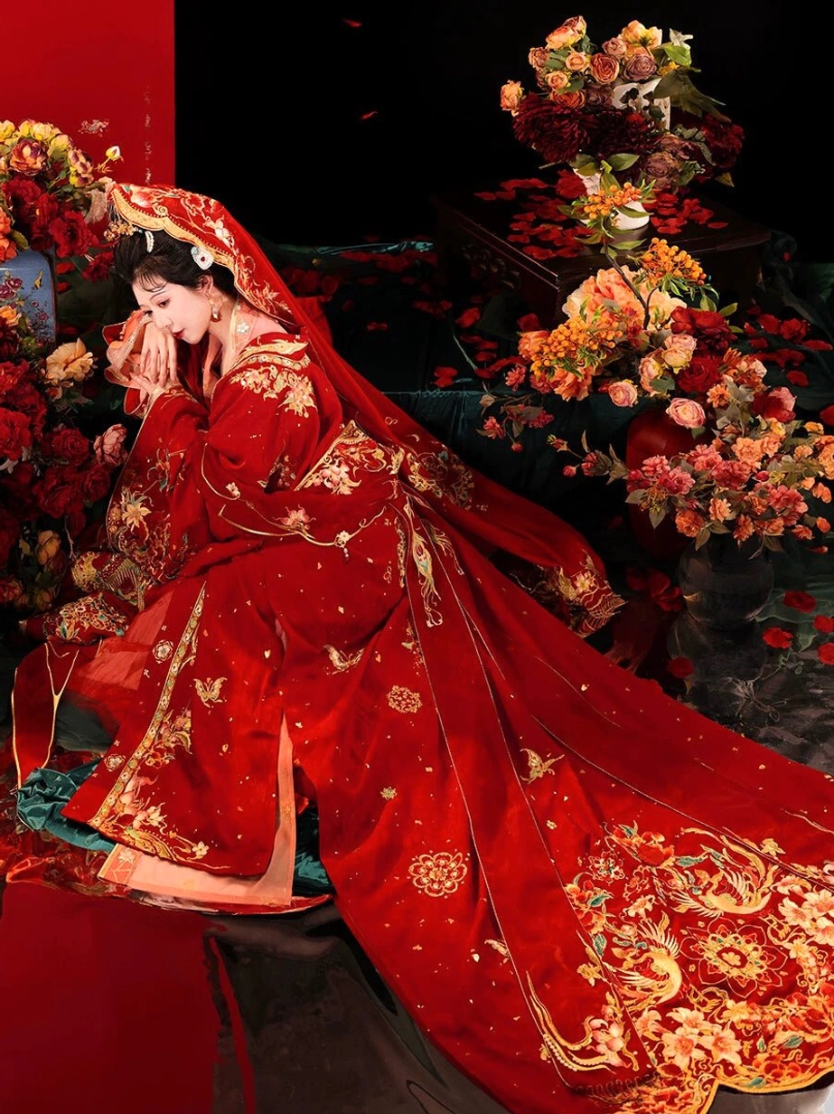 Tang Dynasty Hanfu bridal wedding gown in scarlet red with golden phoenix and floral embroidery, long trailing train, red bridal veil, and elaborate traditional Chinese hair ornaments