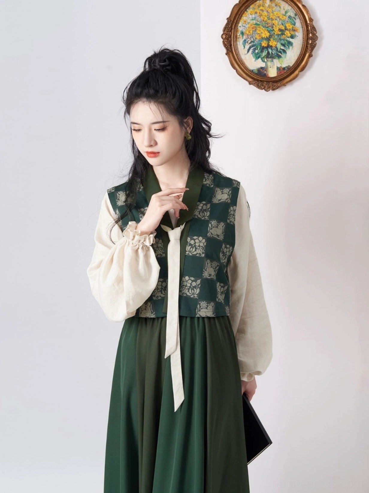 Close up view of modern Tang Dynasty Hanfu upper layers showing the dark green floral jacquard Beizi and detachable white necktie