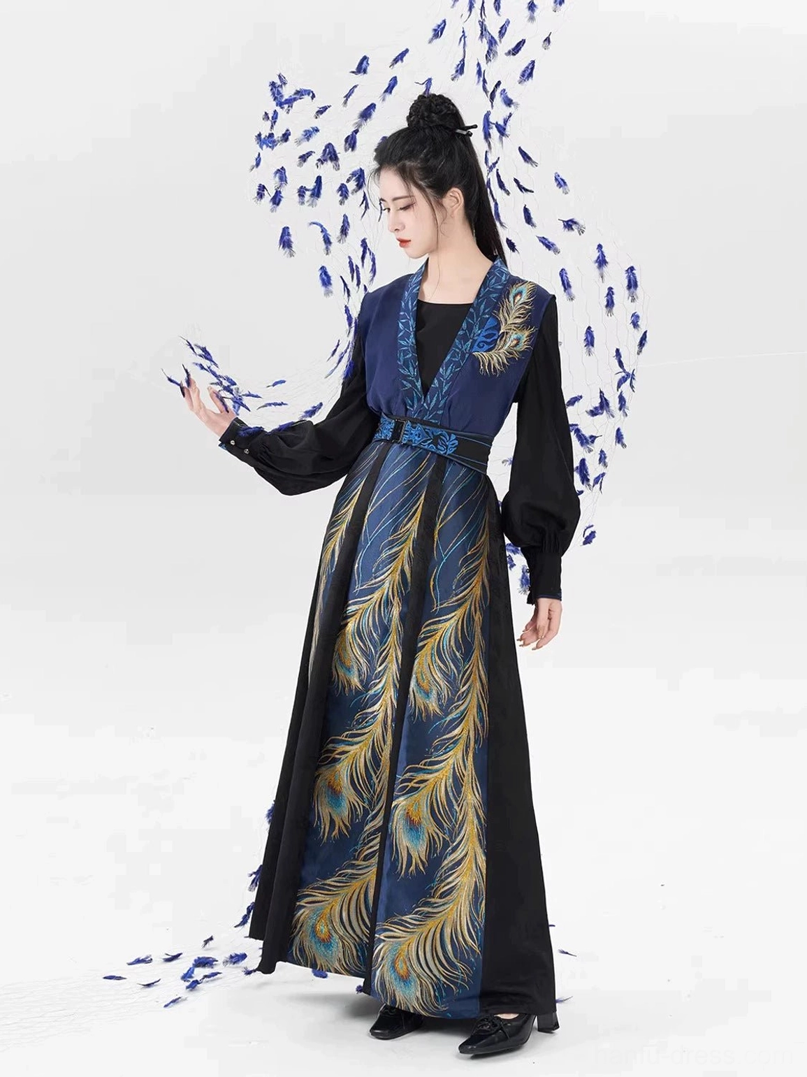 Three-quarter view of an elegant Tang Dynasty hanfu full set with blue beizi vest, gold feather motifs, waist belt, and flowing skirt