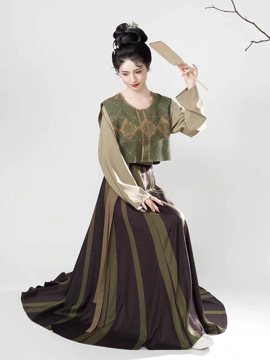 Seated model wearing a complete Tang Dynasty Hanfu set with flowing eight-panel striped skirt, long-sleeve inner top, elegant cuffs, and traditional hairstyle