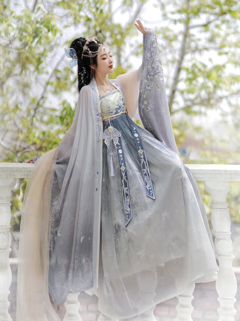 Side view of blue Tang Dynasty style Hanfu Heziqun dress set with embroidered outer robe, flowing layered skirt, decorative waist sash and tassel details