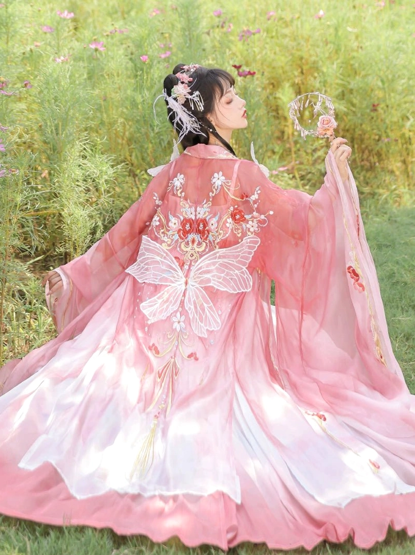 Back view of Tang Dynasty style Hanfu Heziqun dress with pink to white ombre skirt, butterfly embroidery, and flowing wide sleeves
