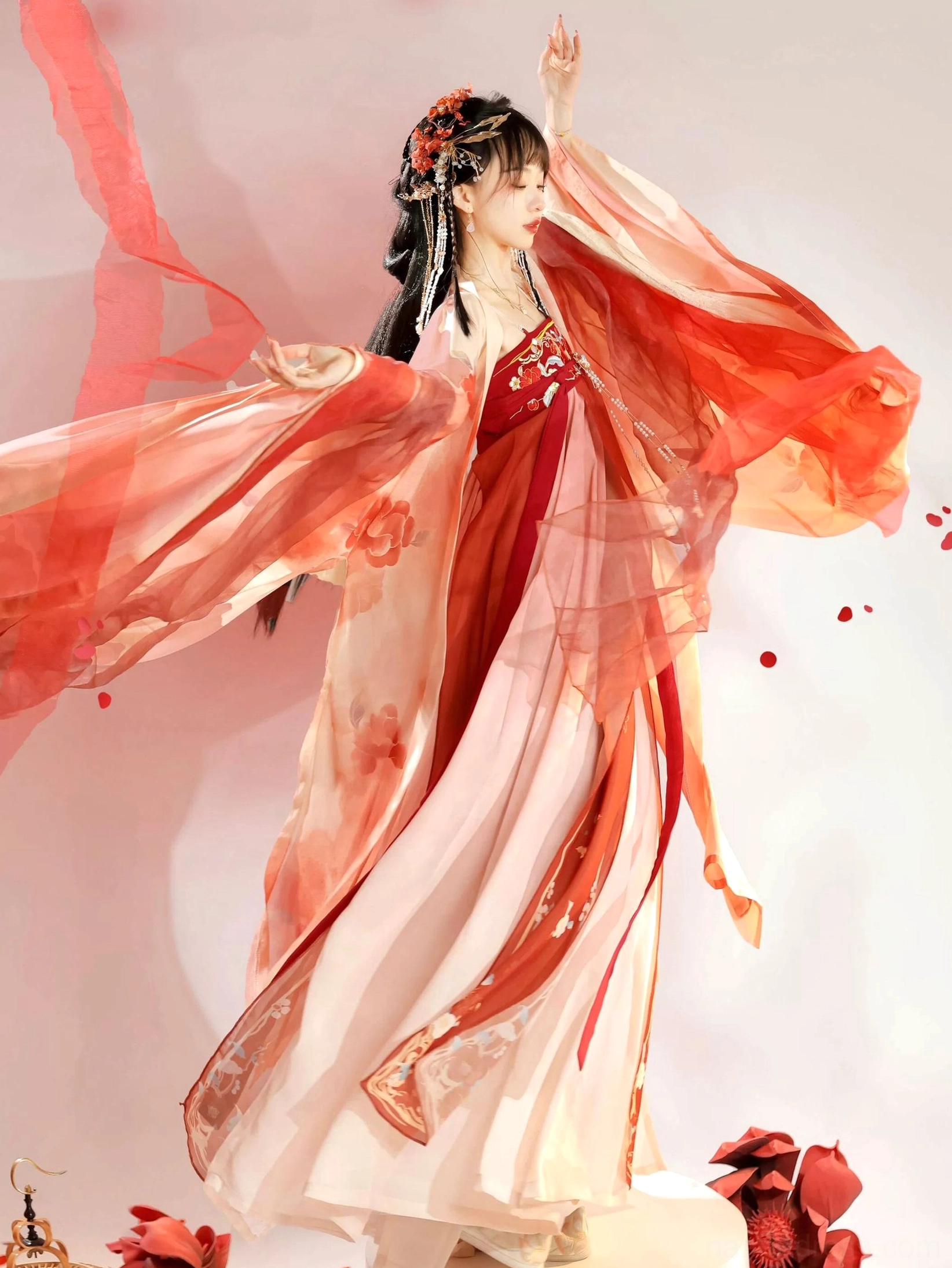 Dynamic full-body view of a female model dancing in a red and pink Tang Dynasty Hanfu Heziqun dress with flowing sleeves and embroidered waist details