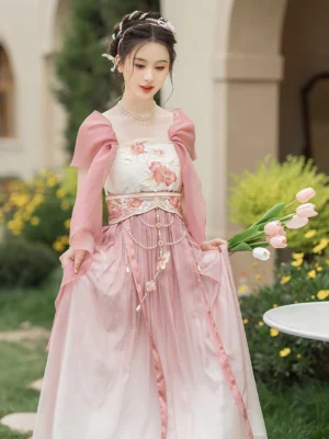 Front three-quarter view of a Tang Dynasty Hanfu Heziqun dress with ombre pink and white tulle skirt, floral embroidered bandeau bodice, sheer shawl, waist chain details, and flowing traditional Chinese styling