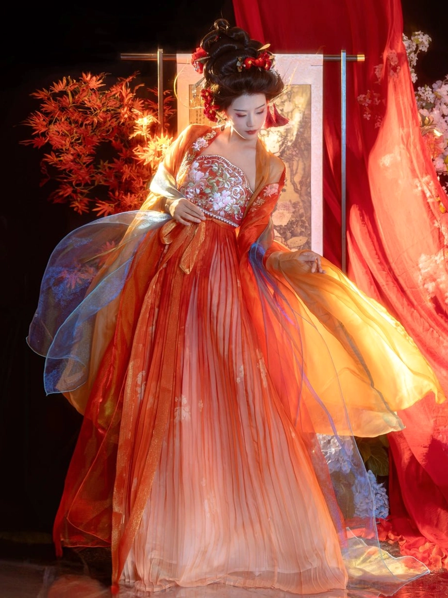 Tang Dynasty Hanfu Heziqun dress shown in a three-quarter front full-body view with a floral embroidered bust bodice, orange pink gradient pleated skirt, and sheer blue orange big sleeve coat