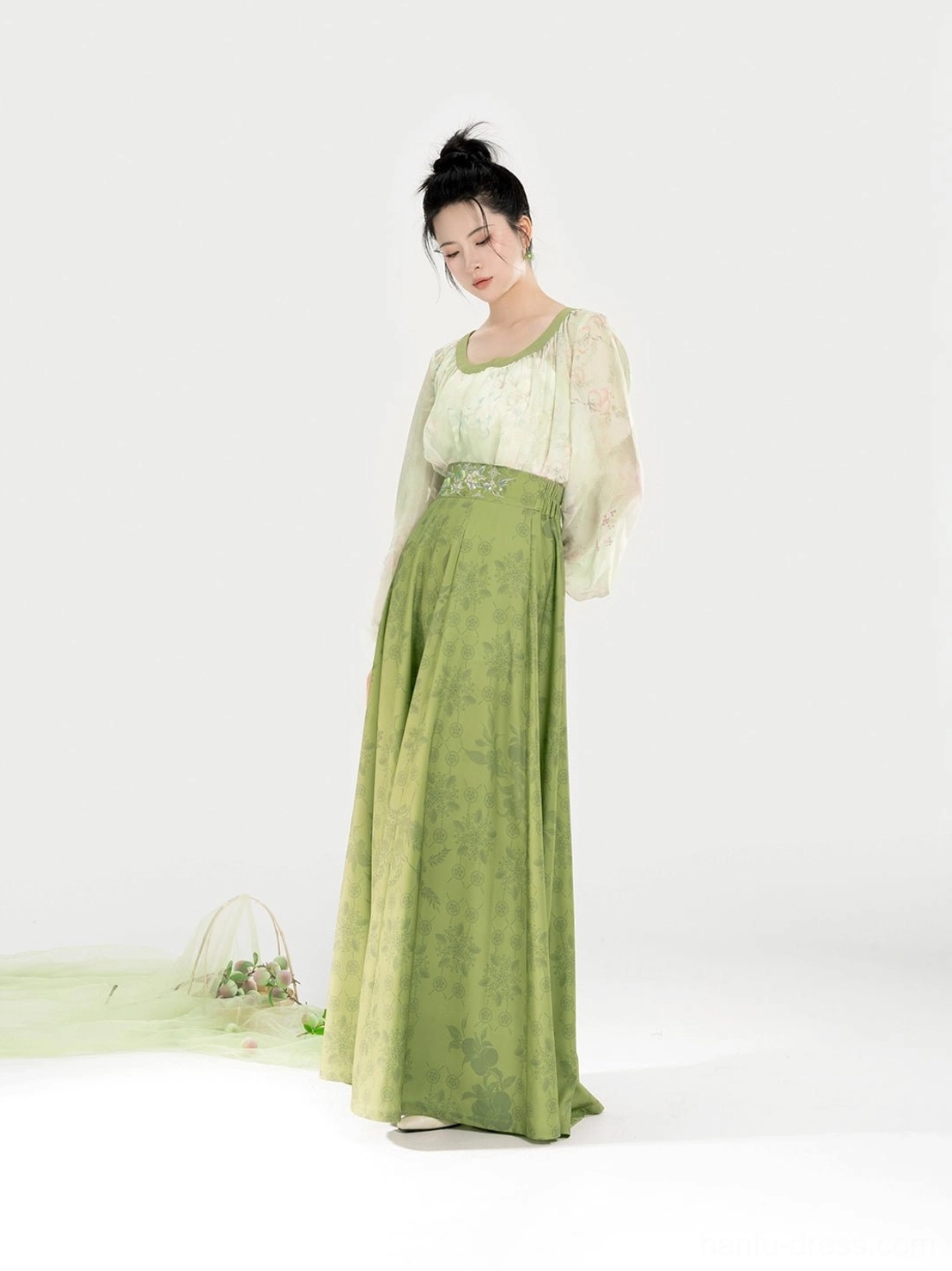 Side view of an elegant Tang Dynasty Hanfu set featuring a high-waisted silhouette, floor-length flowing skirt, and coordinated ivory and sage green colors
