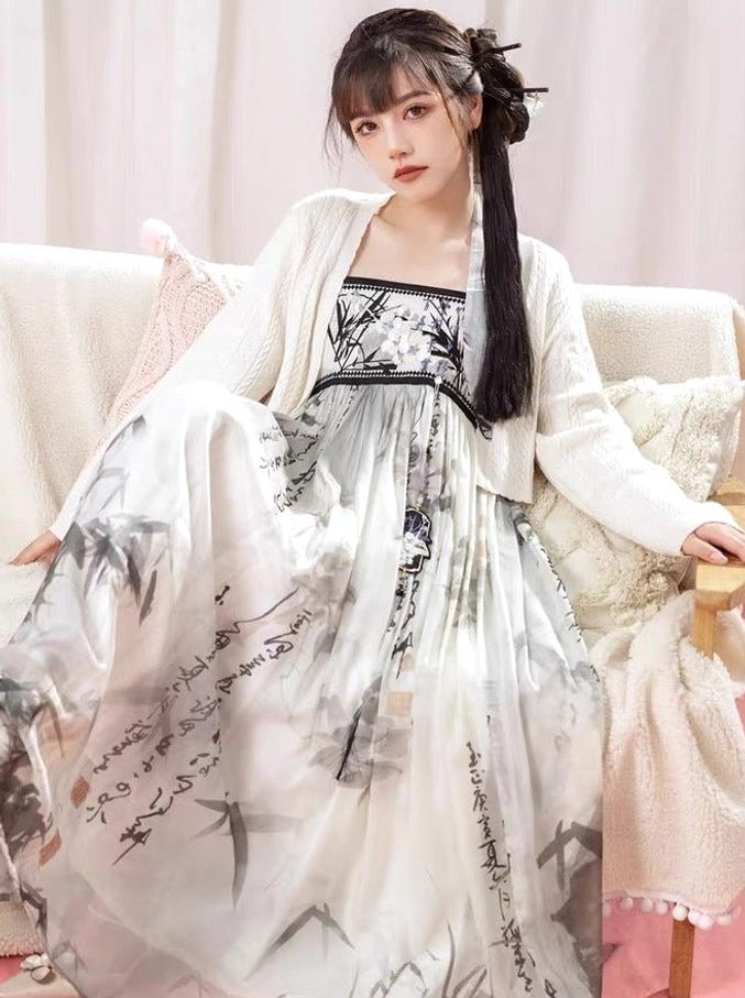 Seated front view of Tang Dynasty Hanfu inspired ink wash maxi dress featuring orchid print calligraphy skirt and cropped cardigan