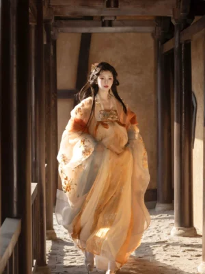 Full-length Tang Dynasty style Qixiong Ruqun Hanfu with golden yellow gradient fabric, floral embroidery, flowing skirt, and dramatic big sleeves