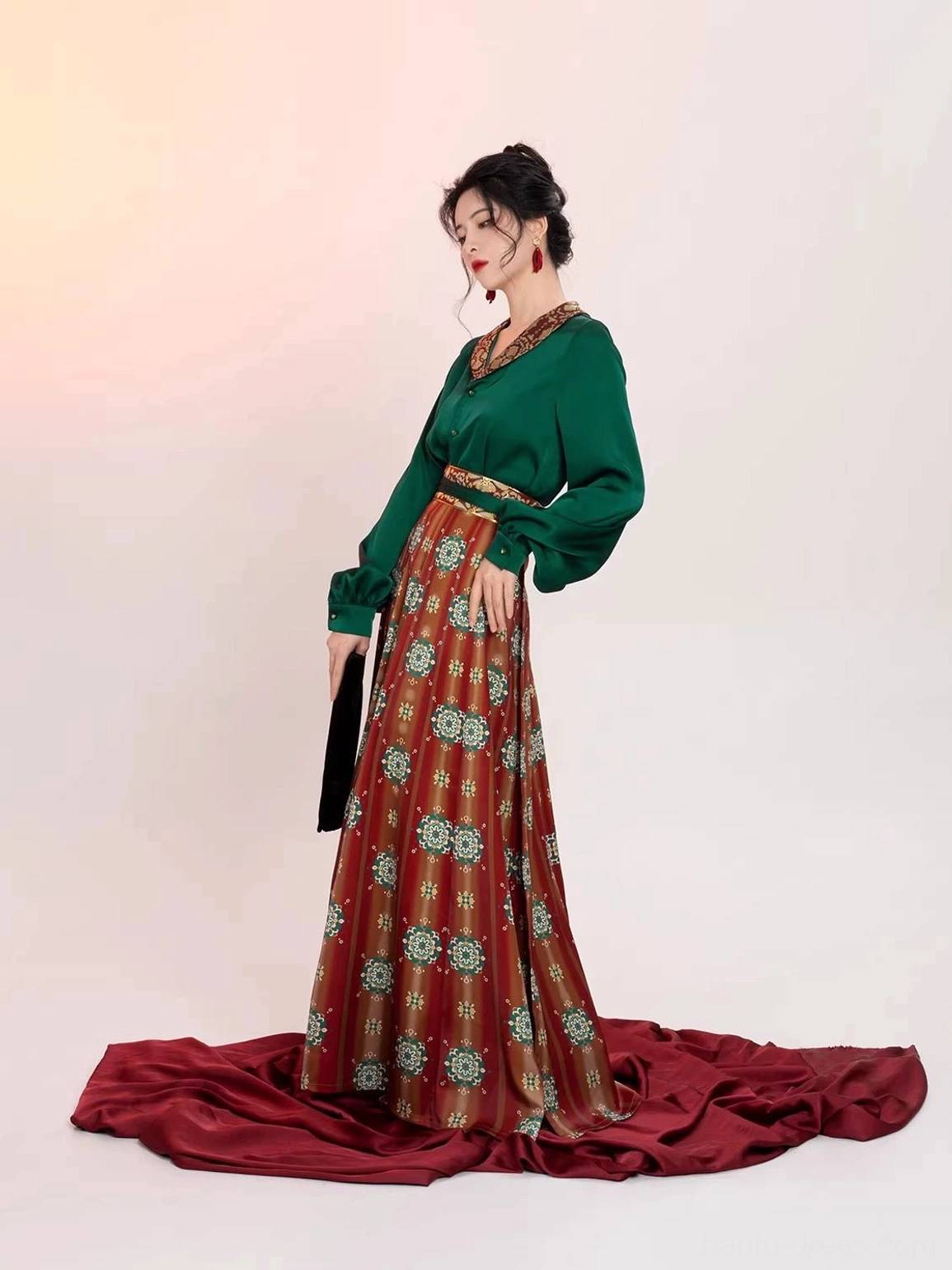Side view of a flowing Tang Dynasty Hanfu set showing the graceful silhouette, long sleeve satin top, high-waisted wrap skirt, and fluid drape of the traditional inspired outfit