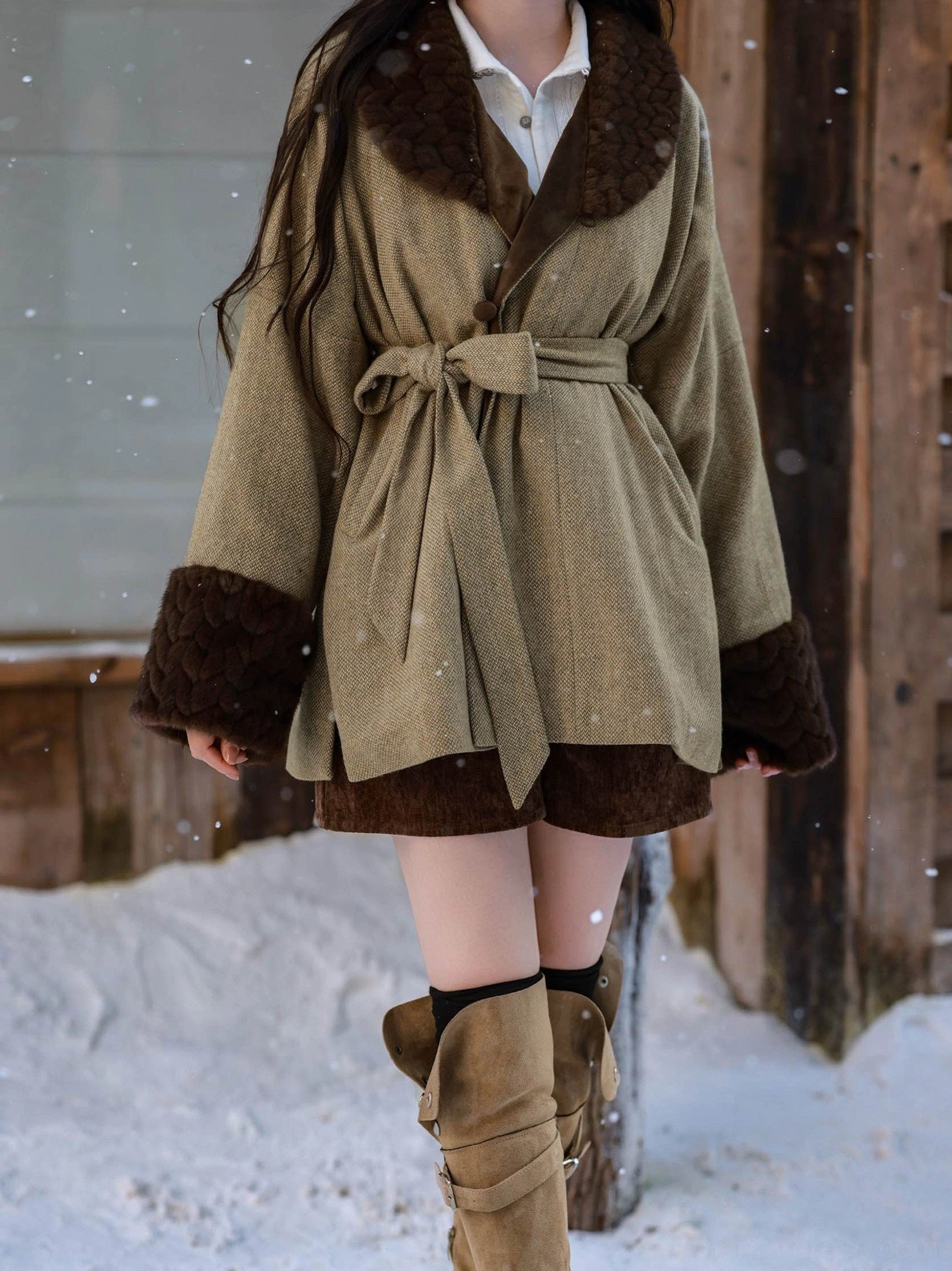 Close-up view of an olive green Tang Dynasty hanfu wool jacket with dark brown fuzzy collar and cuffs, double-breasted front, and waist belt