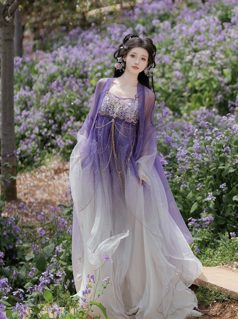 Front three-quarter view of a Tang Dynasty Hezi Hanfu dress with embroidered bust top, gold decorative waist chains, and long purple gradient skirt