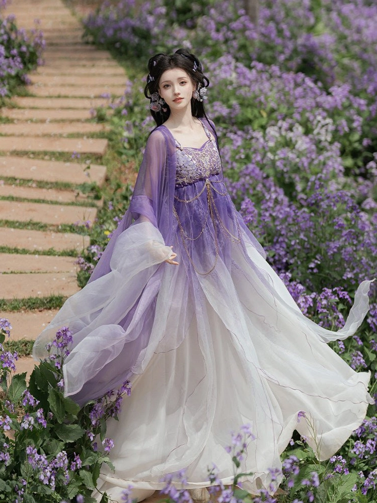 Side angled view of a Tang Dynasty-inspired Hanfu dress displaying soft skirt folds, translucent wide sleeve jacket, and coordinated purple and ivory colors