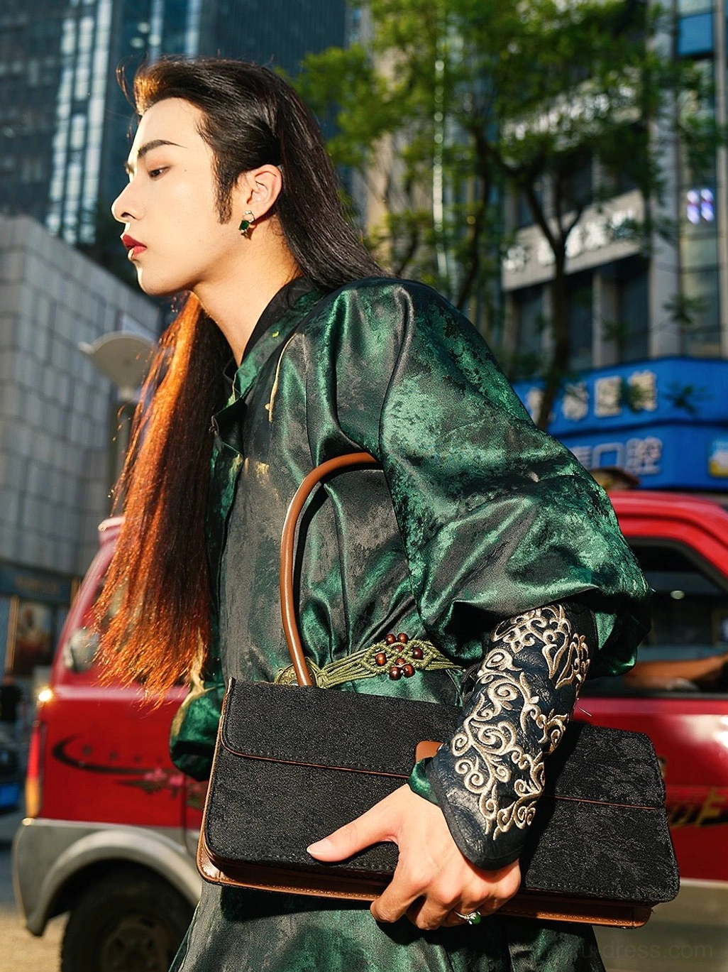 Close-up side profile showing the embroidered cuff pattern, dark green jacquard satin fabric, ornate metal waist belt, and long sleeve details of the Ink River Tang Dynasty Hanfu robe