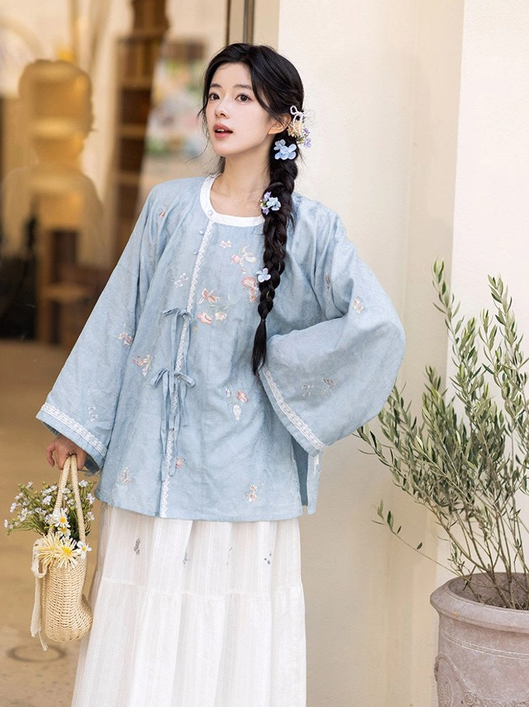Side view of Tang Dynasty inspired blue embroidered Hanfu shirt and white cotton tiered skirt outfit