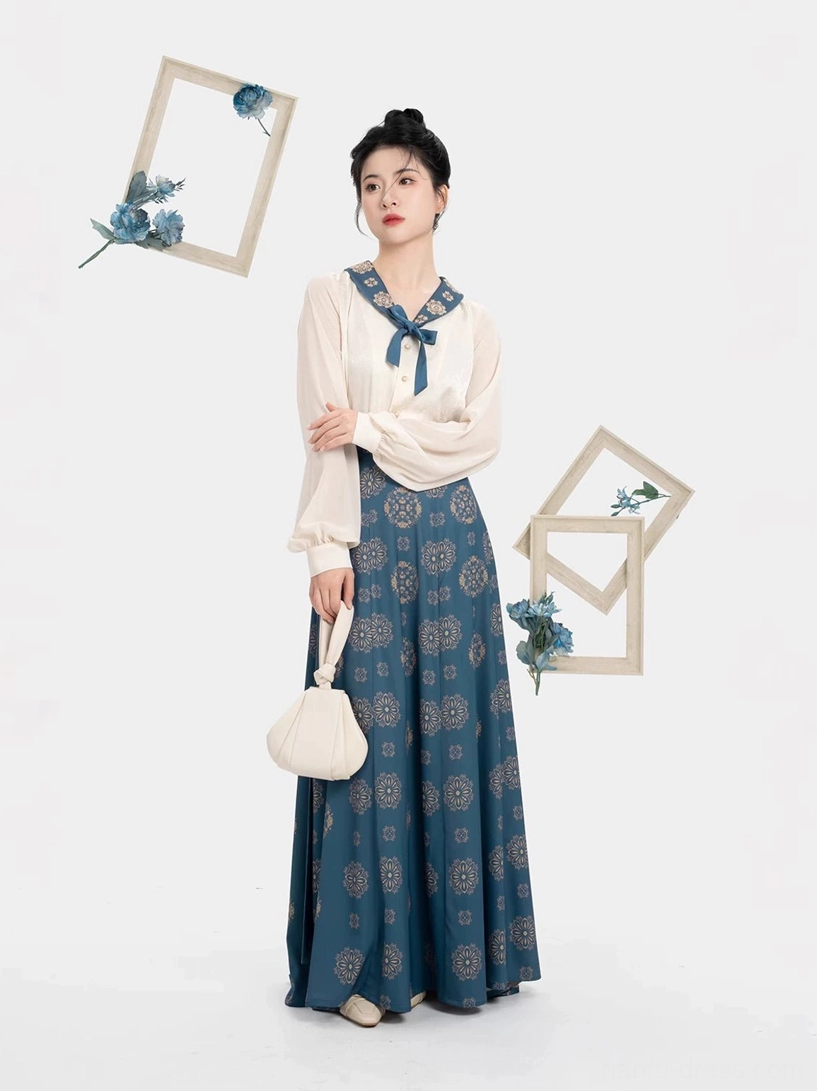 Front view of a Tang Dynasty inspired daily hanfu set with cream long sleeve blouse tucked into a high-waisted navy floral nine-panel skirt