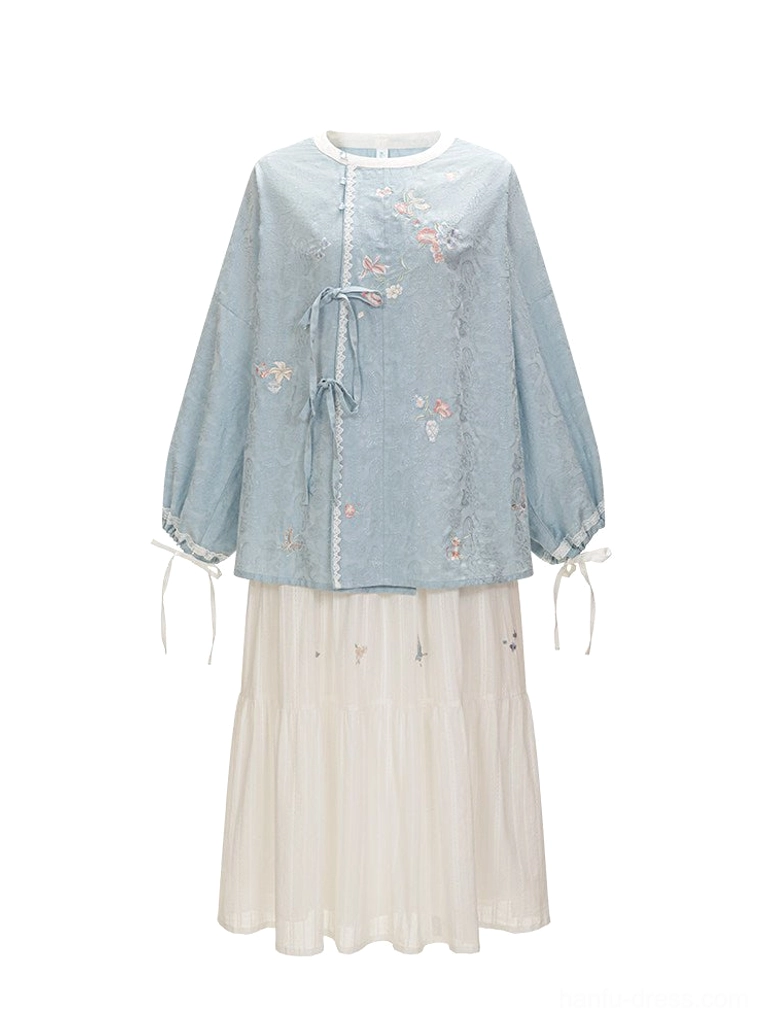 Flat lay of Tang Dynasty inspired Hanfu full set with blue tie front embroidered top and white tiered skirt