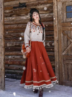 Tang Dynasty inspired Hanfu sweater and pleated wrap skirt set with folk embroidery and tassel details three quarter view