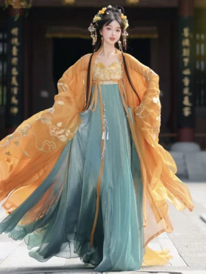 Amber orange Tang Dynasty Qixiong Ruqun hanfu shown from the front with embroidered wide sleeve outer robe, golden inner top, teal floor length skirt, and traditional Chinese hairstyle in an ancient courtyard