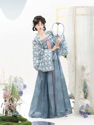 Three-quarter view of a Tang Dynasty style Qixiong Ruqun Hanfu matching set with blue cardigan, sky-blue dress, pink trim, and round silk fan