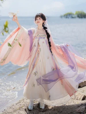 Tang Dynasty style Qixiong Ruqun hanfu with flowing sheer pink and purple sleeves and floral embroidered skirt by the seaside