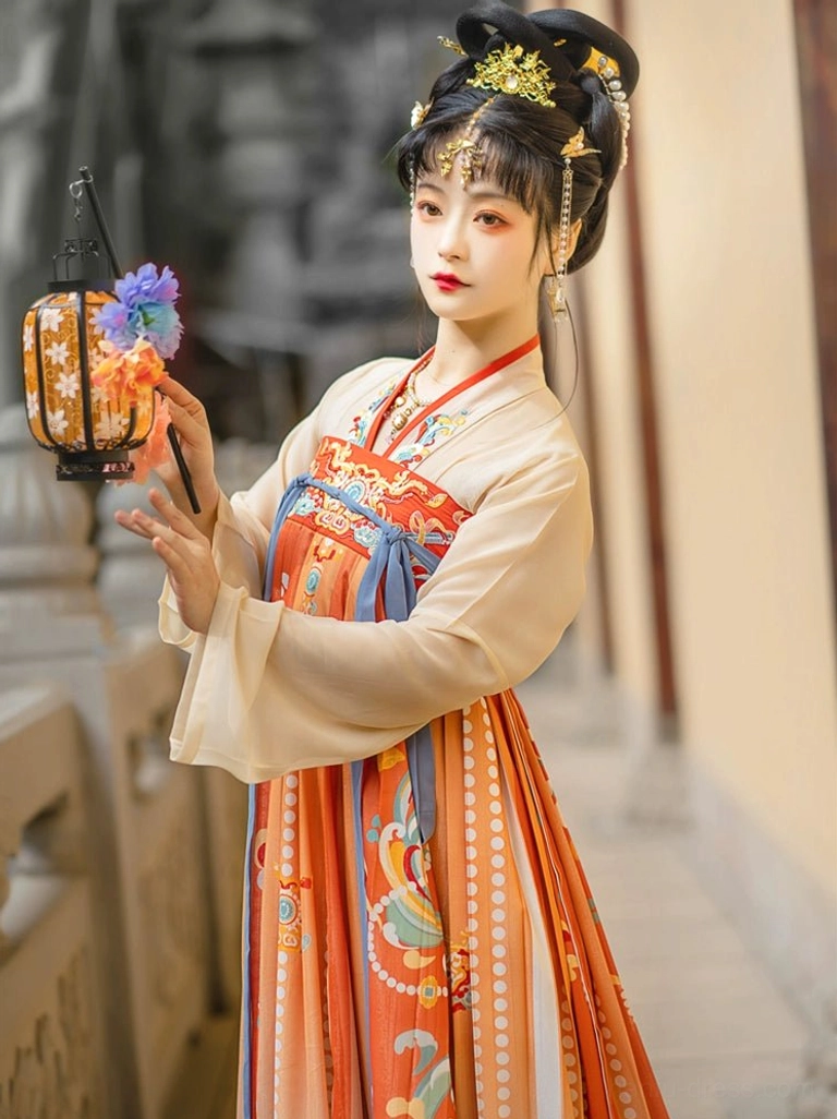 Close-up of Tang Dynasty Qixiong Ruqun Hanfu inner top and patterned high-waisted skirt with apricot cross-collar design and blue waist sash