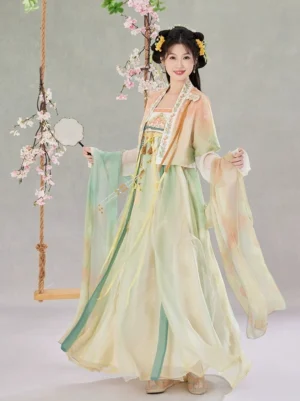 Three-quarter front view of a Tang Dynasty style Qixiong Ruqun Hanfu with sheer cropped outer jacket, white layered cuffs, flowing skirt, and palace fan