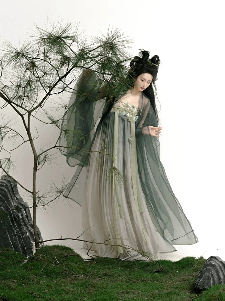 Elegant side view of Tang Dynasty Qixiong Ruqun Hanfu beside pine branches, showing a loose silhouette, natural pleated skirt drape, sheer robe, and classic high-waisted styling