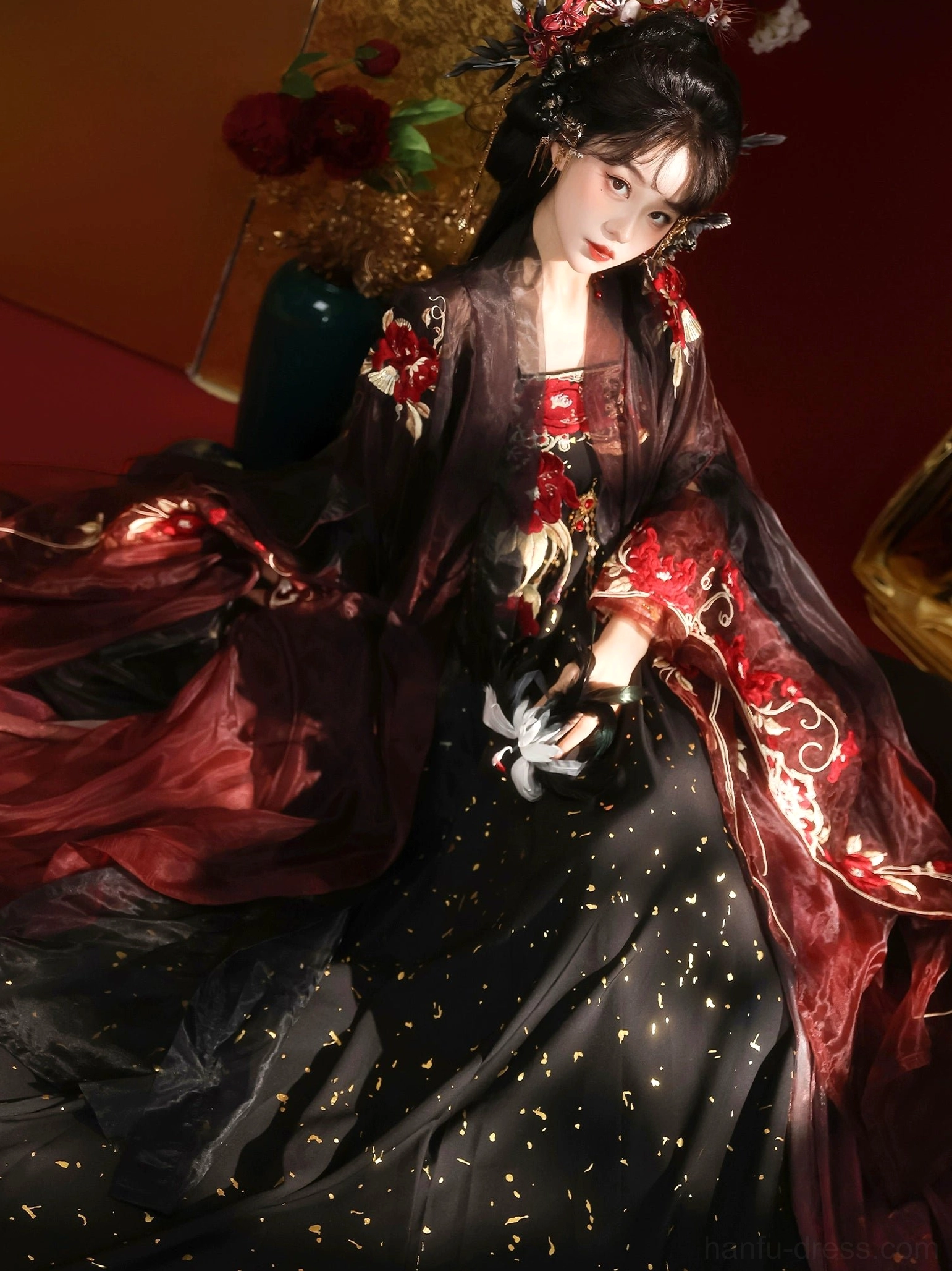 Three-quarter side view of Tang Dynasty Qixiong Ruqun Hanfu showing gold foil speckles on the black skirt, floral collar embroidery, and flowing sheer wine red sleeves