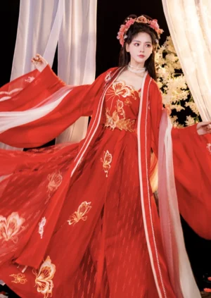 Front full-length view of a red Tang Dynasty bridal hanfu wedding gown with golden butterfly and lotus embroidery, wide flowing sleeves, pearl neckline trim, and traditional Chinese bridal hair ornaments