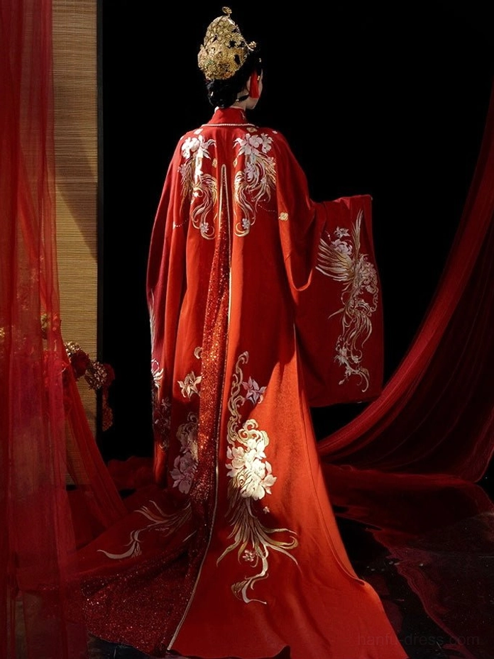 Full back view of crimson Tang Dynasty bridal Hanfu outer robe with large gold phoenix embroidery and sweeping train