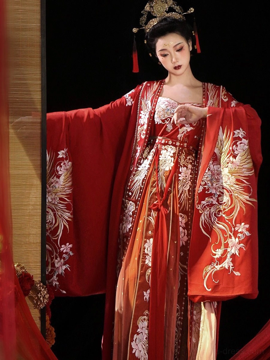 Three quarter front view of red Tang Dynasty bridal Hanfu with gold phoenix embroidery and gradient ceremonial skirt