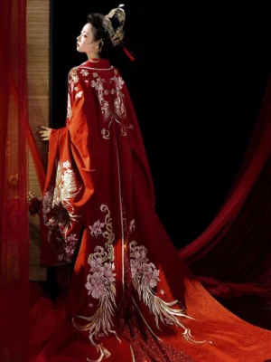Rear left view of Tang Dynasty red phoenix bridal Hanfu wedding gown with long embroidered train and wide sleeves
