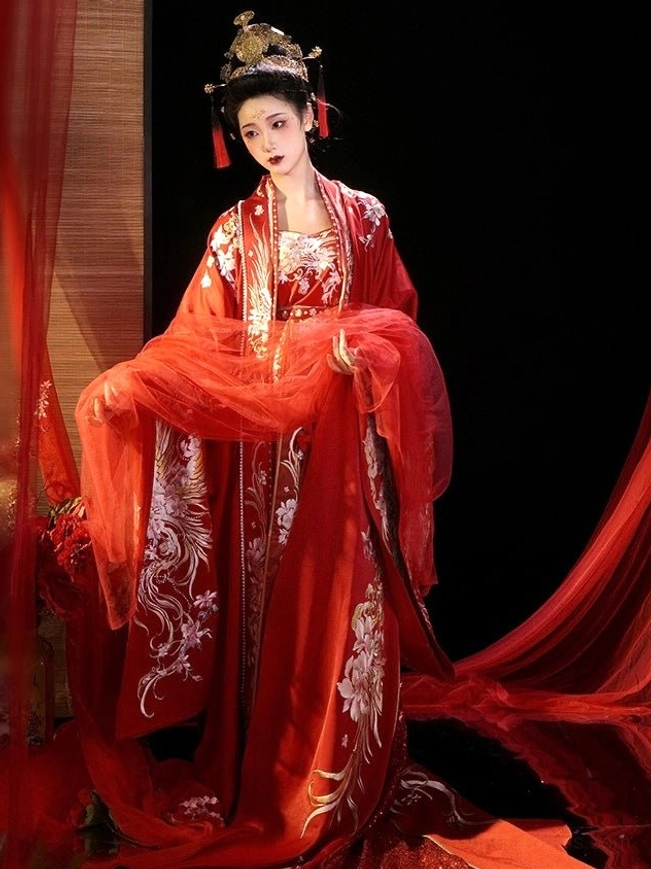 Tang Dynasty red bridal Hanfu with wide embroidered sleeves and translucent red veil fabric in a formal bridal portrait