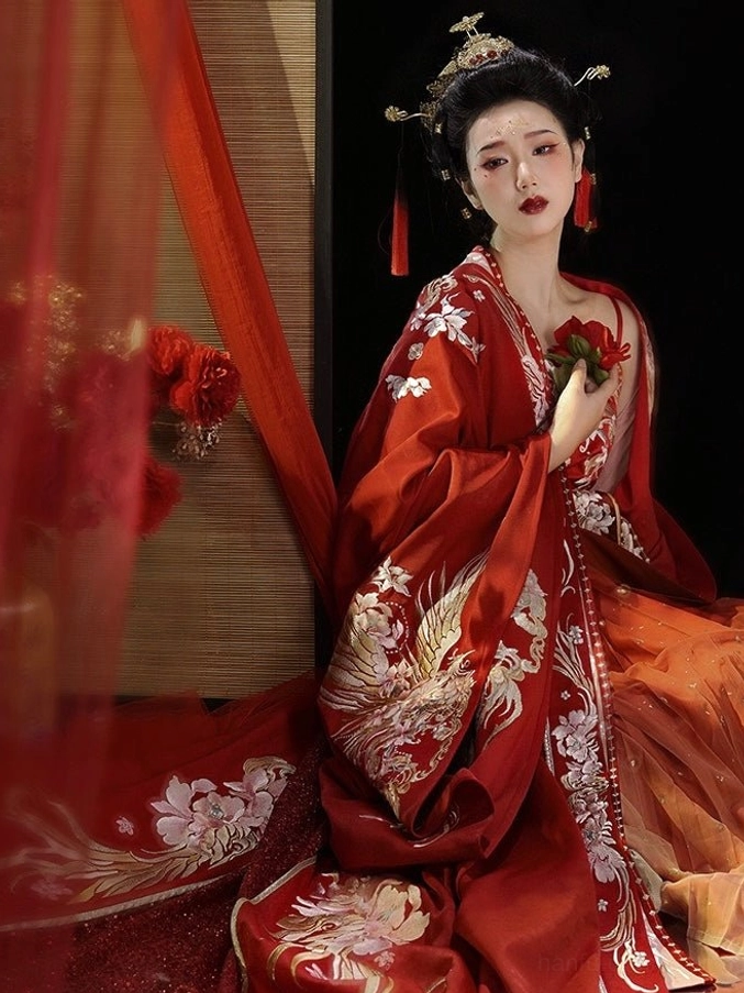 Seated bride wearing red Tang Dynasty bridal Hanfu wedding gown with embroidered sleeves and flowing ceremonial skirt
