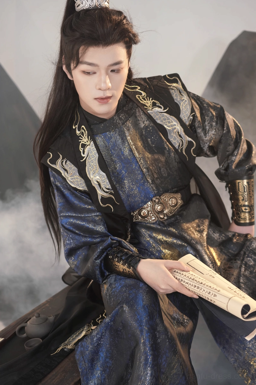 Close three-quarter portrait of a male model wearing a dragon embroidered Tang Dynasty round collar hanfu with ornate waist belt, metal arm guards, and layered black and navy robes