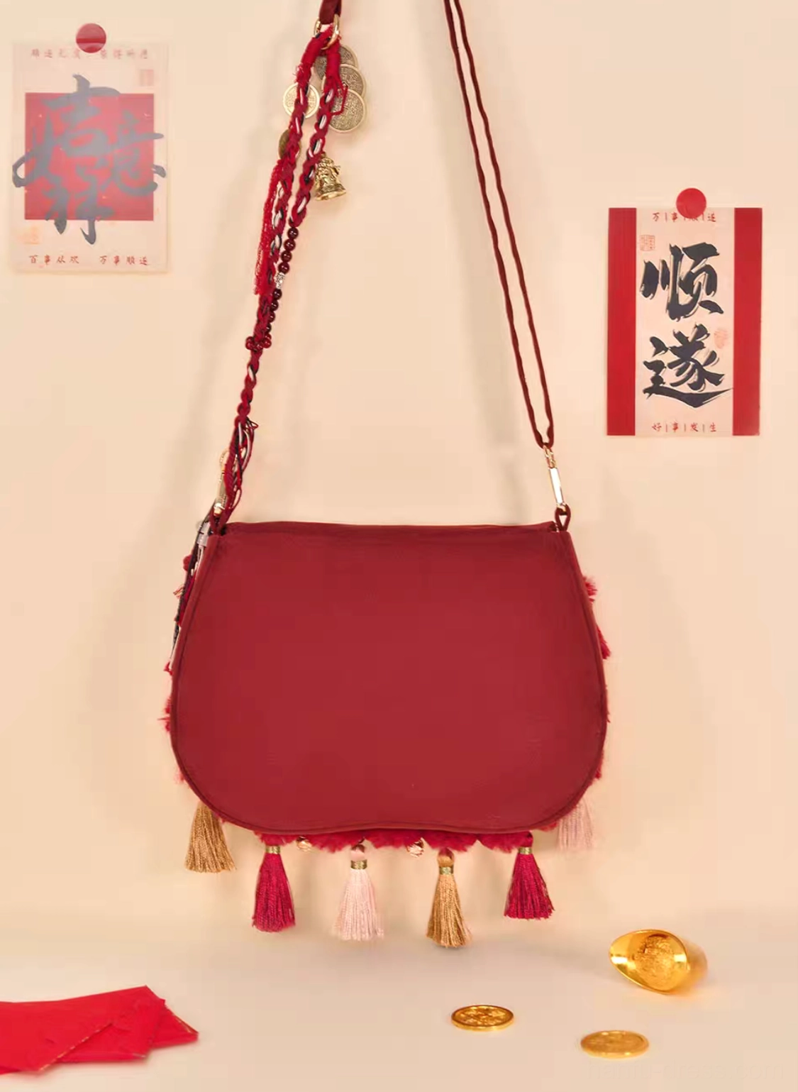 Back view of burgundy Tang-inspired tassel Chinese crossbody bag with plain exterior and decorative tassel trim on Lunar New Year themed backdrop