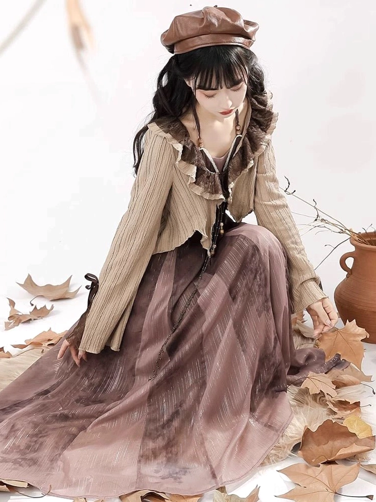 Side sitting view of a Tang-inspired Hanfu dress with textured khaki knit cardigan, vintage beret, and flowing brown ink-print skirt