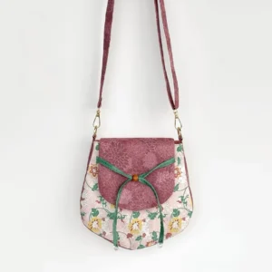 Tang-inspired spring garden floral Chinese crossbody bag with mauve flap green ribbon bow and matching shoulder strap front view