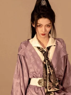 Upper-body close-up of a taro purple round-neck Hanfu robe showing woven jacquard fabric, printed neck scarf, and ornate white waist belt
