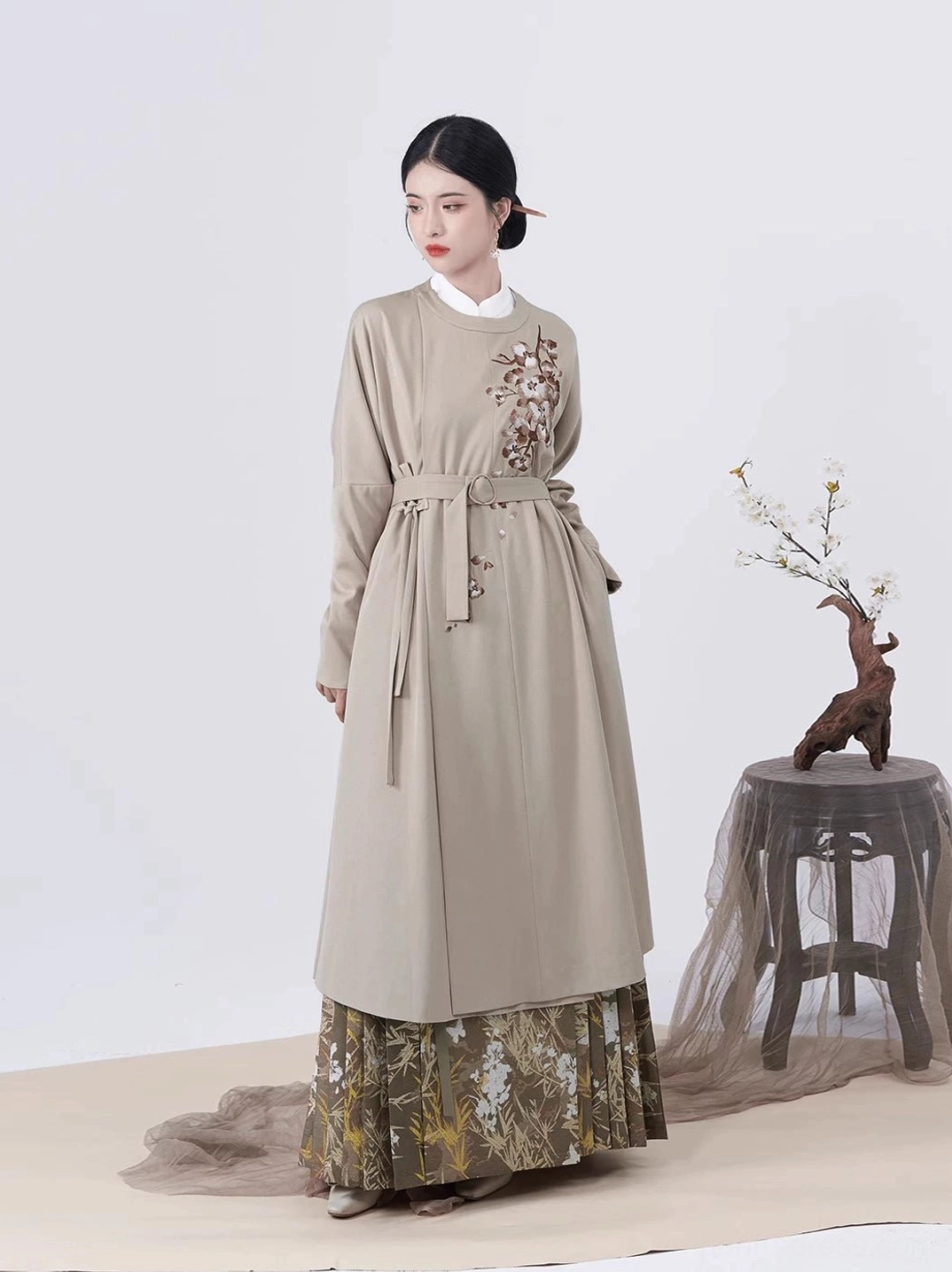 Taupe embroidered Ming Dynasty Hanfu long coat with stand collar, floral chest embroidery, adjustable waist belt, and side split hem