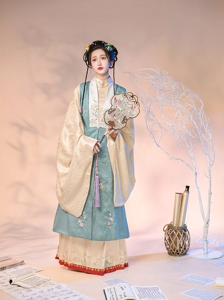 Teal embroidered Ming Dynasty hanfu set with beige inner robe pink mamian skirt red hem trim and floral hair ornaments