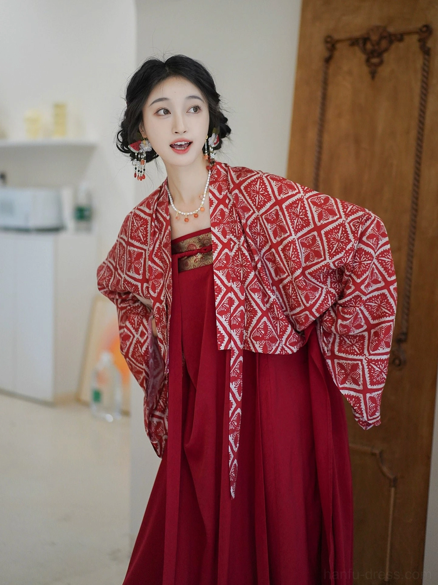 Close-up view of a modern Tang Hanfu cardigan with red and white diamond pattern, wine-red dress neckline, traditional hairstyle, and vintage jewelry