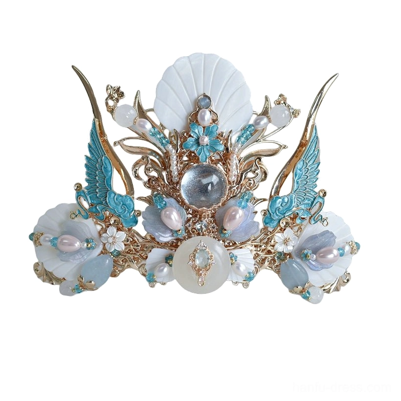 Close front view of Tidal Sea Spirit Hanfu crown with gold-tone base, blue enamel-style wing details, shell-inspired centerpiece, pearl-like beads and gem accents