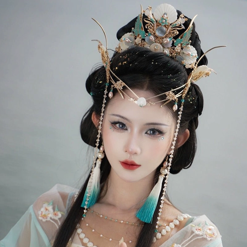 Front portrait of model wearing Tidal Sea Spirit Hanfu hair accessory set with intricate gold metalwork, blue shell-inspired accents and pearl-studded forehead chain