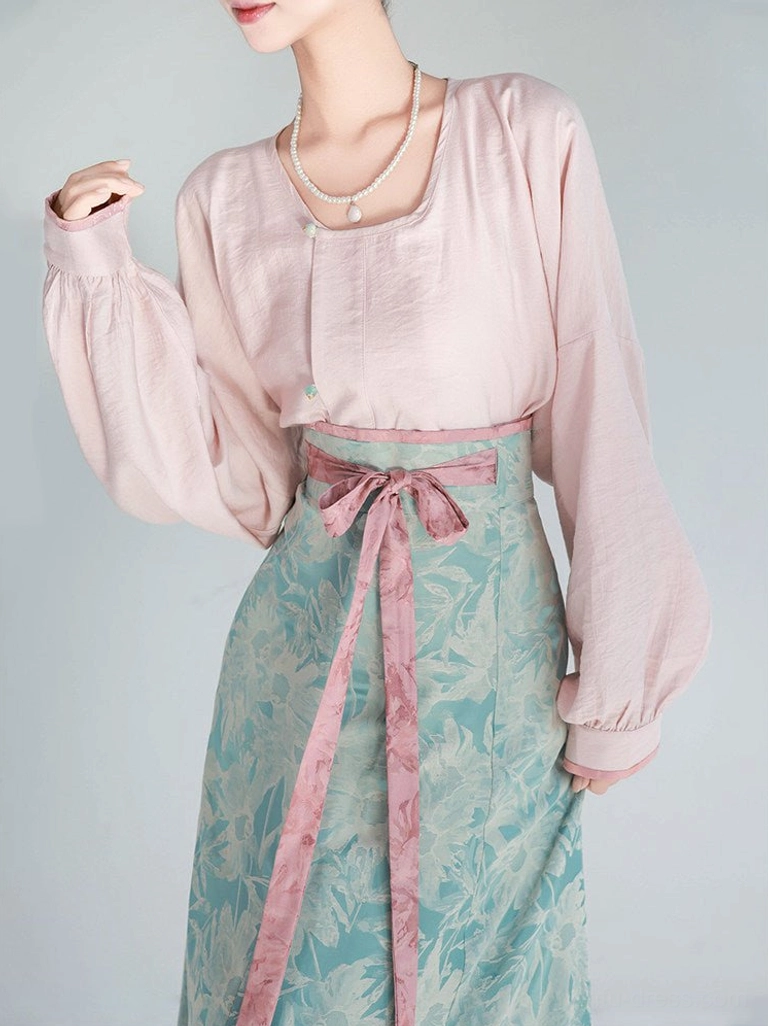 Front three-quarter view of Tiffany Glaze Tang Dynasty Hanfu set with blush pink lantern sleeve top and floor-length cyan skirt