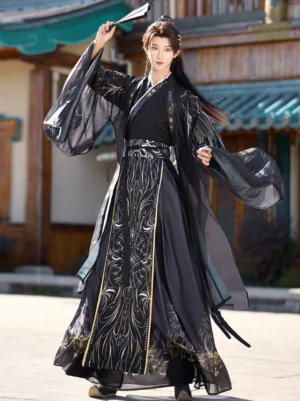 Black and gold Wei Jin Dynasty hanfu for men shown in a front three-quarter full-body view with flowing sheer wide sleeves and embroidered wrap skirt