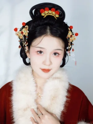 Traditional Chinese bridal hairstyle with butterfly hanfu hair pins, red tassel ornaments, and a gold hair crown styled with a red hanfu and white fur collar
