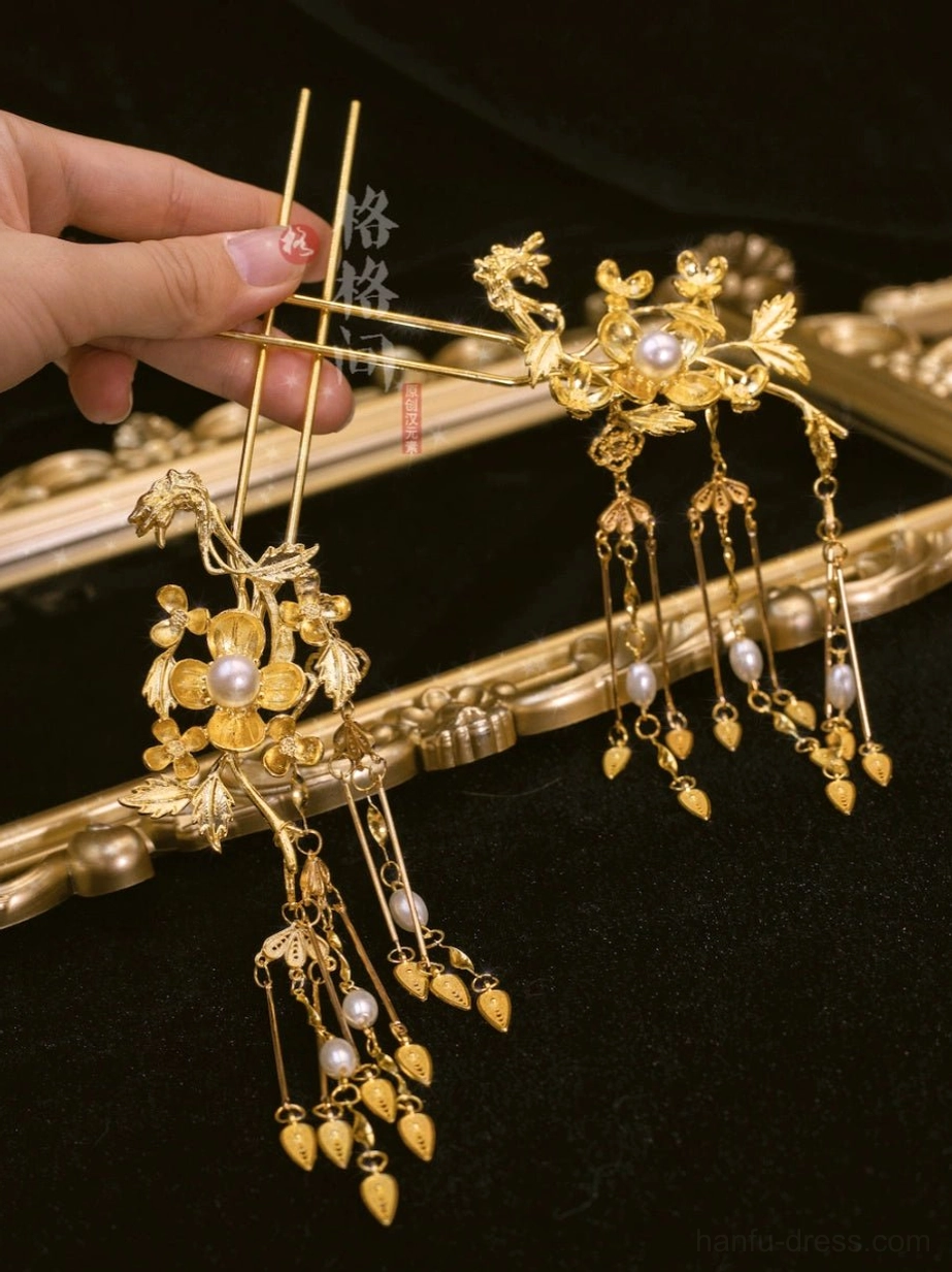 Traditional Chinese double-pronged hair pins with gold floral decoration, white pearls, and shorter dangling tassel details